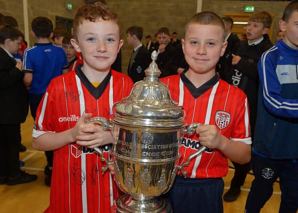 St Columb's College pupils Cadhan Downey and Conor McLaughlin pictured with the FAI Cup during a visit to the school on Monday by Derry City players Michael Duffy, Liam Mullan and Jordon McEneff. Photo: George Sweeney. DER2247GS - 21