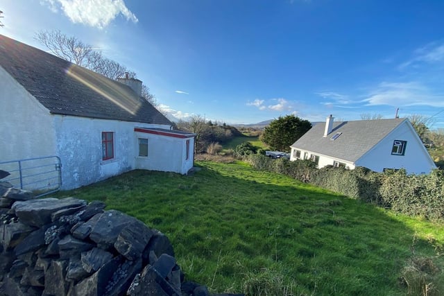 This cottage, on left, in an idyllic corner of the Donegal Gaeltacht popular with Derry holiday makers is to go under the hammer at auction next month.