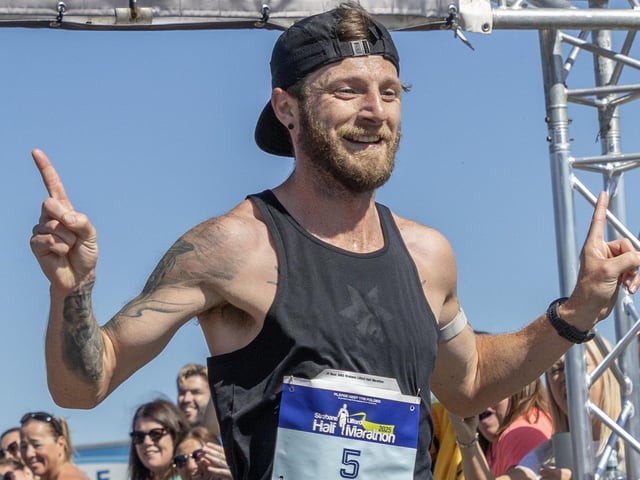 Stephen McCauley can't hide his joy as he finishes the race in 1:10:18.