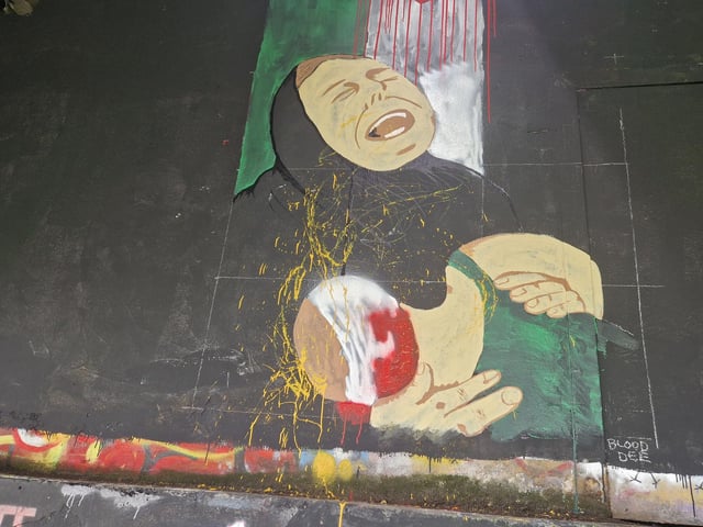 A mural depicting a grieving Palestinian woman holding a dying or sick child was also daubed with paint in the attack.