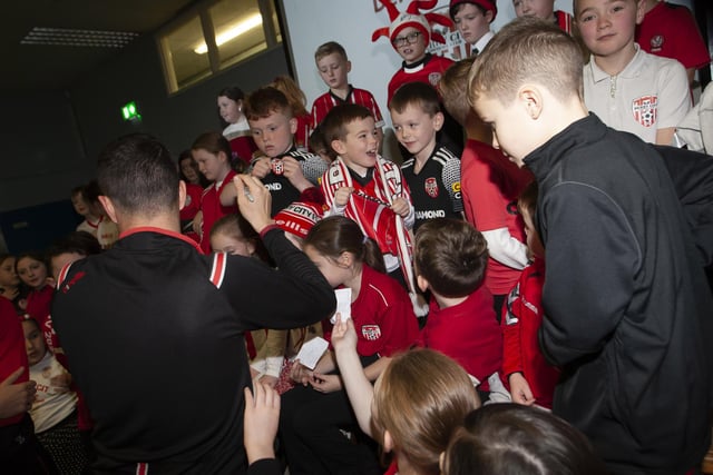 Derry City star Michael Duffy gets mobbed for autographs at Greenhaw PS.