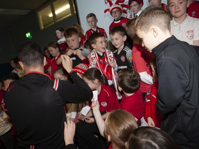 Derry City star Michael Duffy gets mobbed for autographs at Greenhaw PS.