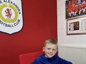 James Junior McClean signs forms for Crewe Alexandra.
