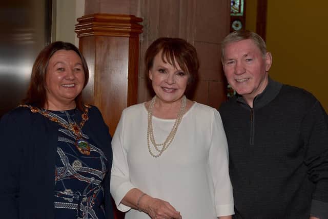 The Mayor of Derry City and Strabane Colr. Michaela Boyle and Charlie Nash, former professional British and European lightweight boxing title holder greet Dana on her arrival at the Guildhall, on Wednesday afternoon last, for rendition of her 1970 Eurovision Song Contest winning song 'All Kinds of Everything' with local people. DER4719GS - 008