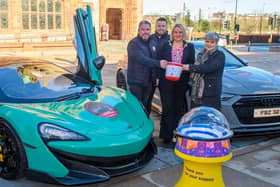 The Mayor Councillor Sandra Duffy pictured with Gary and Stephen McCaul and Eileen Best from this years Mayoral Charity, First Housing Aid and Support Services as they launch Supercar Saturday which is taking place on the 13th of May. Two of the stars which will be on display are a Maclaren and an Audi RS7. Picture Martin McKeown. 14.03.23