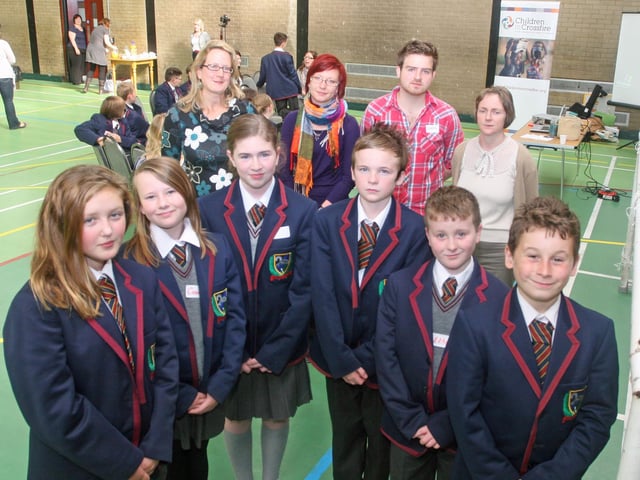 A selection of Year 8 pupils from Oak Grove College who attended an International Peace Workshop at Pilot's Row Community Centre. At back, left to right: Helen Henderson (Children in Crossfire), Agniesza Luczak (Polish Abroad), Chris McIlllindon (Children in Crossfire), and Judi Logue, Eden Place Arts Centre. 2409JM23