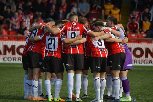 TEAM EFFORT . . . Derry City players believe they can still topple Rovers.