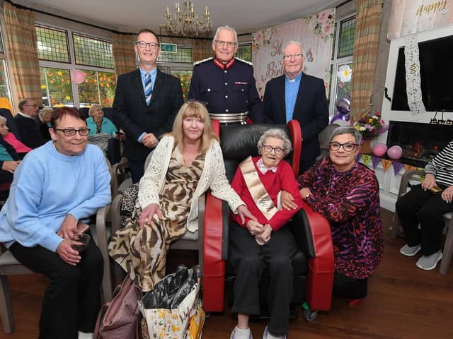 Centenarian Alfreda Astbury pictured with members of her family and (standing) the Reverend David Brownlow, Ian Crowe, the Kings Lord-Lieutenant for the County Borough of Londonderry and the Very Reverend David McNie during birthday celebrations at Ebenballymore Lodge Care Home. Photo: George Sweeney