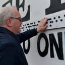 Richard Moore, from Children in Crossfire pictured at the unveiling of a Braille sign at Free Derry Corner on Tuesday afternoon Included in the photo is John Kelly, Museum of Free Derry. Photo: George Sweeney. DER2305GS – 62