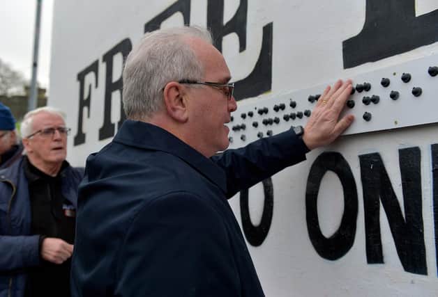 Richard Moore, from Children in Crossfire pictured at the unveiling of a Braille sign at Free Derry Corner on Tuesday afternoon Included in the photo is John Kelly, Museum of Free Derry. Photo: George Sweeney. DER2305GS – 62