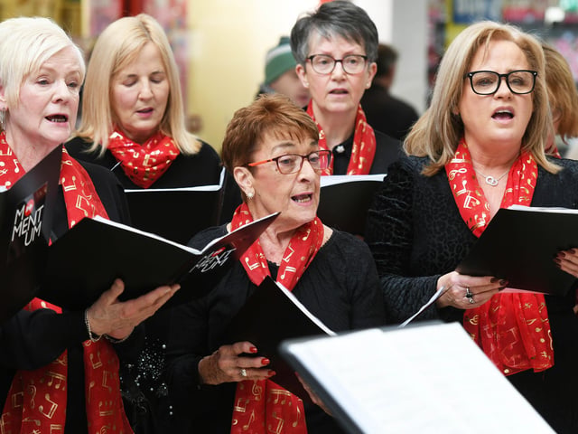 Momentum Choir members singing at Foyleside Shopping Centre.