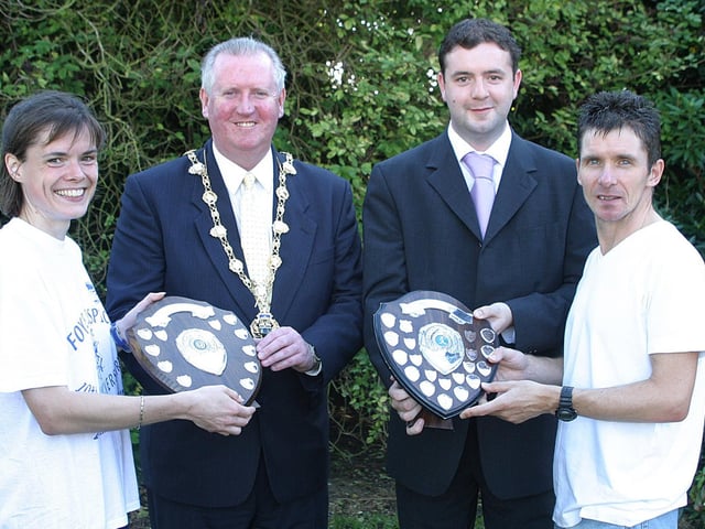 The Mayor of Derry Councillor Shane Gallagher presents  a shield to Sheelagh Bodkin, Sparta AC, who was the first local female to finish the Waterside half-Marathon, and Dermot Parke,  with Automated Vending, co-sponsors of the race, presents a shield for the first local male finisher to Damien McGinty. (1609T57).:.