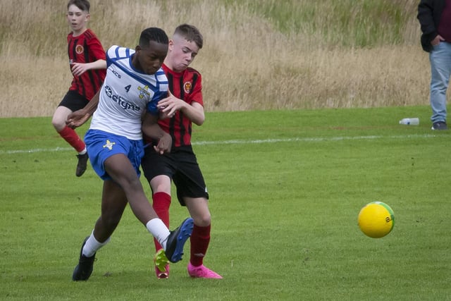 St. John’s Eli Okambawa clears his lines during Monday’s first round game against Hillsborough Boys at Templemore. (Photos: Jim McCafferty Photography)