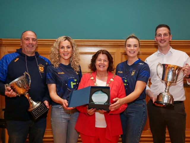 The Mayor of Derry and Strabane, Councillor Patricia Logue presents a civic gift to mark the reception to joint captains Aoife McGough and Ciara McGurk. Included are Thomas Cusack, manager, and club chairman, Paul O'Hea, holding the County and Ulster Championship trophies.