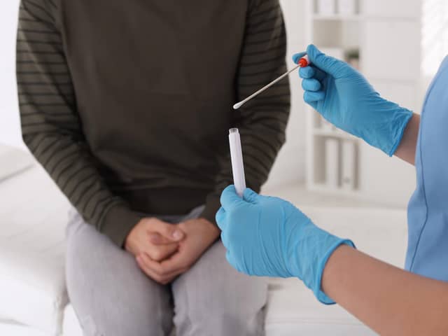 Doctor taking sample for STD testing from man in clinic. (File picture)