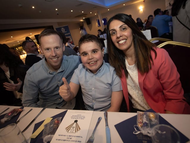 Young Joseph Quigley, a nominee for the Braveheart Award for Courage, pictured at the Derry Credit Union's Young People's Awards on Monday evening with his parents.