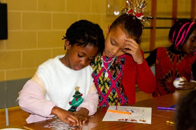 Young people doing Christmas crafts at the African Caribbean Community Network family Christmas party in Derry