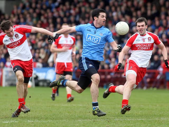 Dublin's Michael Dara Macauley tries to break past Derry duo Benny Heron and Mark Lynch in Celtic Park back in 2014. (Photo Lorcan Doherty / Presseye.com)