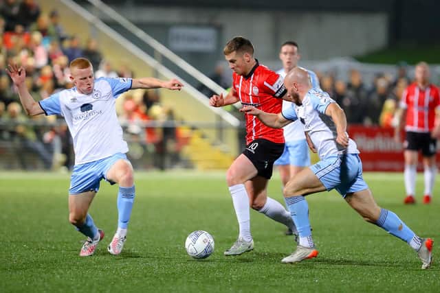 Derry City's Patrick McEleney skips away from Shelbourne duo Gavin Molloy and Mark Coyle.