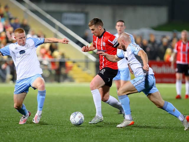Derry City's Patrick McEleney skips away from Shelbourne duo Gavin Molloy and Mark Coyle.