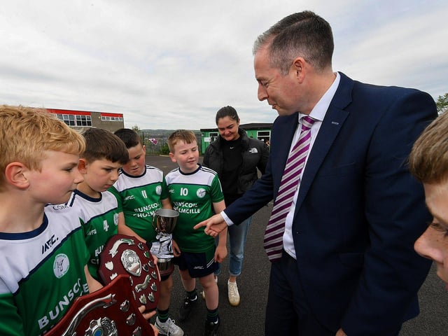 Education Minister Paul Givan is meets members of the gaelic football team during his visit to the Naíscoil Dhoire and Bunscoil Cholmcille, Steelstown, on Wednesday morning. Photo: George Sweeney