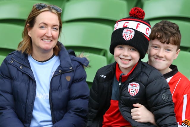 ALL SMILES . . . This young family take their seats ahead of kick-off at the Aviva Stadium.