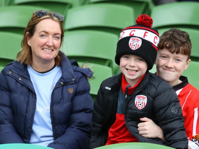 ALL SMILES . . . This young family take their seats ahead of kick-off at the Aviva Stadium.