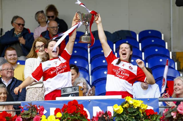 Derry’s Aine McGill and Sinead McGill lift the Jack McGrath Cup after Saturday's Glen Dimplex All-Ireland Intermediate Camogie Championship Final . (Photo: INPHO/Phil Magowan)