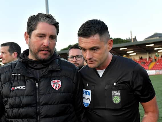 Derry City manager Ruaiddhri Higgins speaks with referee Rob Hennessy after the final whistle. DER2321GS -