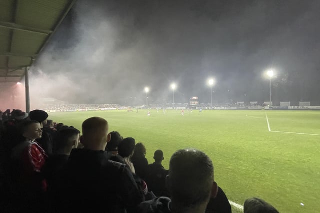 Smoke from flares clouds over the pitch during Friday night's match.
