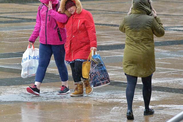 2020: People walking across Guildhall Square during the strong winds and rain brought by Storm Brendan. Further stormy conditions are expected this evening in Derry as Storm Isha arrives. DER0220GS – 007