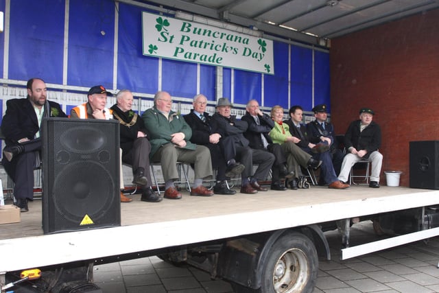 Dignitaries on stage await the arrival of the floats during Buncrana's St. Patrick's Day parade on Sunday. 1903JM25