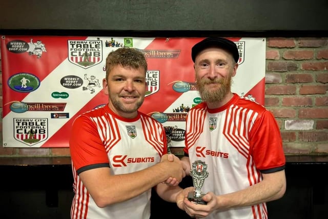 Lawrence Watson, Derry City Table Football Club, presenting the runner-up trophy in the Jimmy Watson Memorial Cup to Marco Bevilacqua.