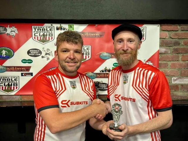 Lawrence Watson, Derry City Table Football Club, presenting the runner-up trophy in the Jimmy Watson Memorial Cup to Marco Bevilacqua.