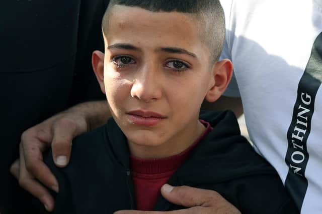 The younger brother of Mahmud Nakhle one of two Palestinian men killed during clashes with the Israeli army in the al-Jalazoun refugee camp, grieves during his brother's funeral in the West Bank city of Ramallah on October 23, 2023, amid the ongoing battles between Israel and the Palestinian Islamist group Hamas. Thousands of people, both Israeli and Palestinians have died since October 7, 2023, after Palestinian Hamas militants based in the Gaza Strip, entered southern Israel in a surprise attack leading Israel to declare war on Hamas in Gaza on October 8. (Photo by Jaafar ASHTIYEH / AFP) (Photo by JAAFAR ASHTIYEH/AFP via Getty Images)