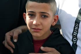 The younger brother of Mahmud Nakhle one of two Palestinian men killed during clashes with the Israeli army in the al-Jalazoun refugee camp, grieves during his brother's funeral in the West Bank city of Ramallah on October 23, 2023, amid the ongoing battles between Israel and the Palestinian Islamist group Hamas. Thousands of people, both Israeli and Palestinians have died since October 7, 2023, after Palestinian Hamas militants based in the Gaza Strip, entered southern Israel in a surprise attack leading Israel to declare war on Hamas in Gaza on October 8. (Photo by Jaafar ASHTIYEH / AFP) (Photo by JAAFAR ASHTIYEH/AFP via Getty Images)