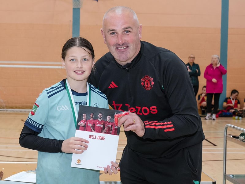 Goalkeeper of the tournament, Lauren Gallagher, receives her award from Manchester United Foundation's Stephen Parkhouse. (Photo: Jim McCafferty Photography)