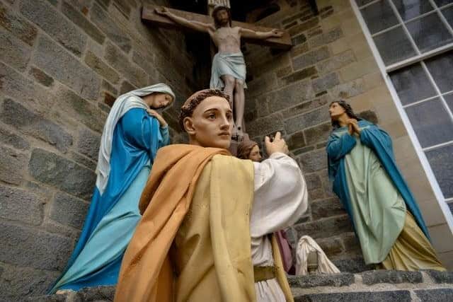St Columba at the foot of the cross at St Columba's Church Long Tower in Derry.
