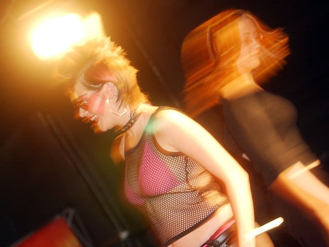 Two students captured in full motion at the NWIFHE's Hairdressing Show.