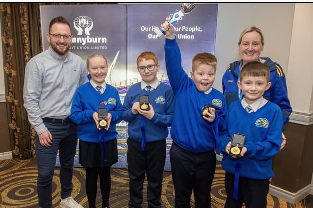 Pennyburn Credit Union School Quiz Competition A Winners St. Paul's P.S. L to R - Frank Doherty (CEO), Sophie, Seamus, Ryan, Lochlainn. See Page 4.