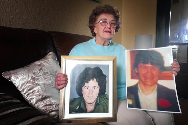 Mrs. Bridie McBrearty pictured in 2015 with images of her late sons George McBrearty, who was killed by undercover British soldiers on May 28, 1981 and Pat McBrearty, who took his own life on May 28, 1991.