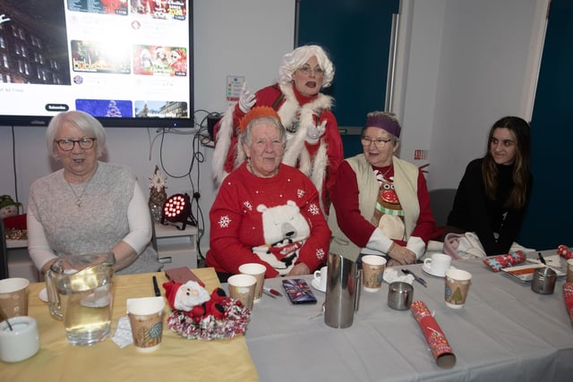 Mrs. Claus entertaining some of the group at last week's Senior Citizens Christmas Party in the Cathedral Youth Club.