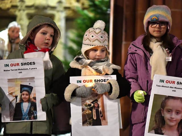 Children carry candles and photographs of children killed in Gaza at a vigil held in Guildhall Square, to mark World Childrens Day, and to remember the lives of children in Gaza. Photo: George Sweeney