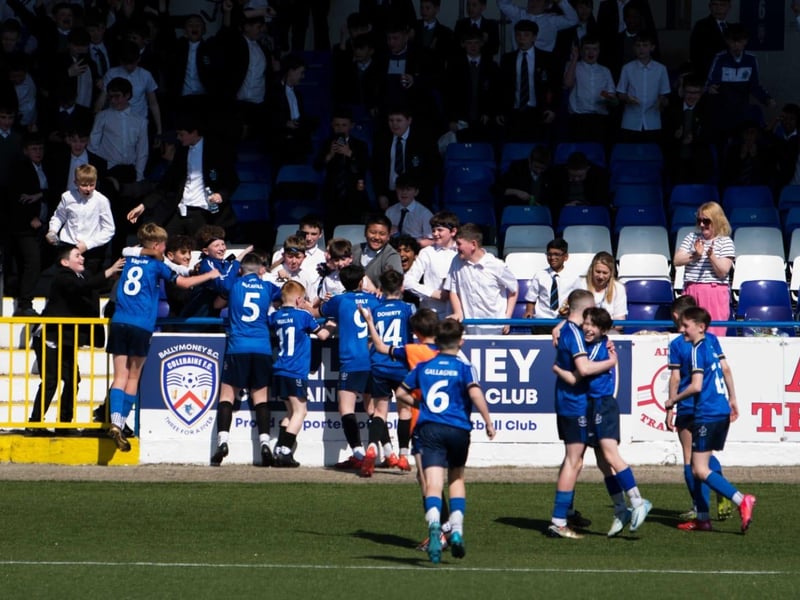 St Columb's College players run into the crowd after scoring against Lisneal in the final.