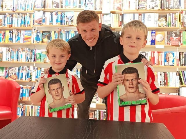 Young Derry City fans Aodhán and Luca pose for a photograph with James McClean.