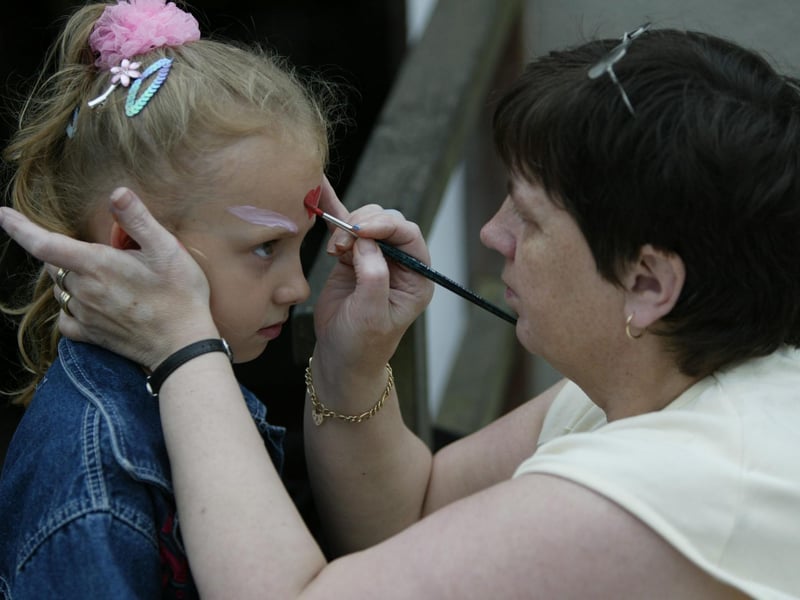 Jordan Sweeney gets a nice pictured painted by Anne Hagan at St, Anne's PS fete.  (0306JB17)