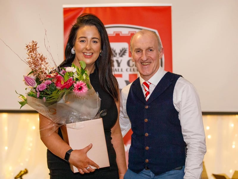 Charlene McGeehan receives club person of the year award from committee member John Hegarty.