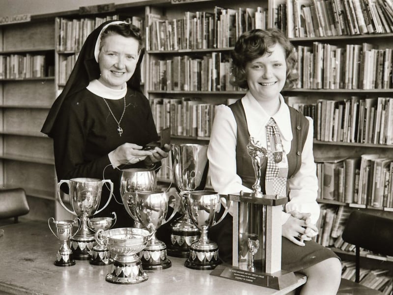 17 year old singer Cathy Murray with staff at St Mary's College displaying some of the trophies she won.