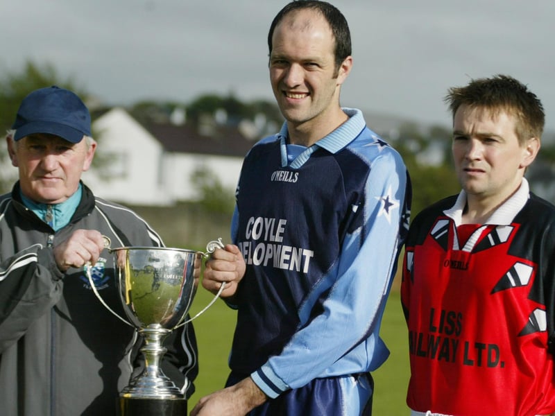 Illes Celtic captain Niall McDaid receives the Knockalla Caravans trophy from Jim McConnell of the Ulster Seior League. ALso in photo is Carndonagh FC captain Phil Doherty. (1305JB14)