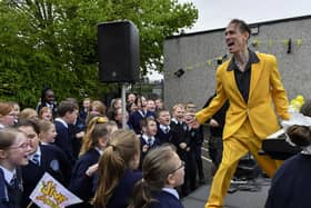 Vince Hurley from the Jive Aces entertaining  pupils from Rosemount Primary School during the band’s visit to the school on Thursday morning. Photo: George Sweeney